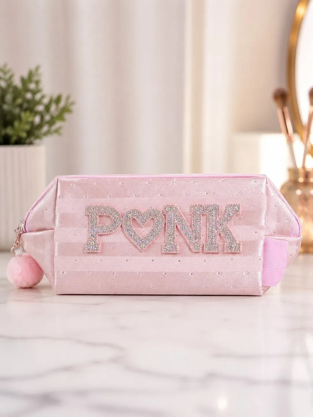 Neceser ÉL&ELLA MAKEUP Y ACCESORIOS rosa pastel satinado con letras brillantes y pompón decorativo